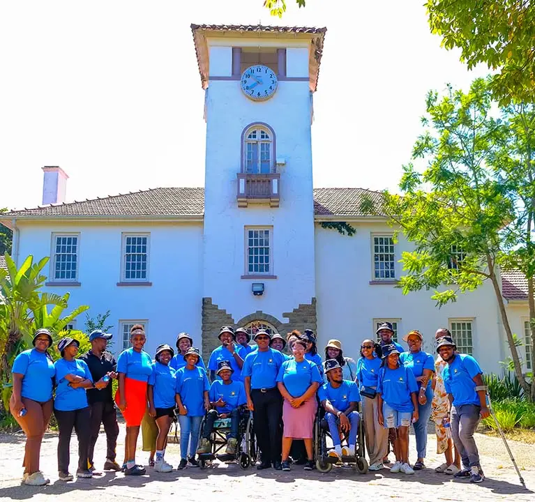 Disability students standing in front of the clock tower